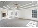 Large bedroom with carpeted floors and a tray ceiling at 1078 Meadow Brook Dr, Woodstock, GA 30188