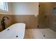 Modern bathroom with freestanding tub, glass shower, and stylish tile at 1122 Nw Rice Nw St, Atlanta, GA 30318