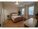 Bright bedroom with hardwood floors, featuring a comfortable bed and workspace at 1122 Nw Rice Nw St, Atlanta, GA 30318