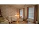 Charming Bedroom featuring a crib, armchair, and pink wallpaper at 1122 Nw Rice Nw St, Atlanta, GA 30318