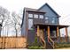 Two-story home with dark siding, copper gutters, and a front porch at 1122 Nw Rice Nw St, Atlanta, GA 30318