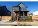 Two-story home with dark siding, copper gutters, and a front porch at 1122 Nw Rice Nw St, Atlanta, GA 30318