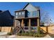 Two-story home with dark siding, copper gutters, and a front porch at 1122 Nw Rice Nw St, Atlanta, GA 30318