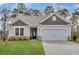 One-story house with gray and beige siding, stone accents, and a two-car garage at 138 Kingsley Way, Acworth, GA 30102