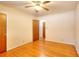 Hardwood floor bedroom with ceiling fan and access to other rooms at 879 Old Tucker Rd, Stone Mountain, GA 30087
