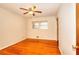 Bright bedroom featuring hardwood floors and a ceiling fan at 879 Old Tucker Rd, Stone Mountain, GA 30087