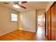 Hardwood floor bedroom with ceiling fan and access to bathroom and other rooms at 879 Old Tucker Rd, Stone Mountain, GA 30087