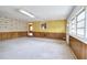 Spacious bonus room with wood paneling and neutral carpeting at 879 Old Tucker Rd, Stone Mountain, GA 30087
