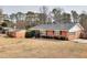 Brick ranch house with a large yard and mature trees at 879 Old Tucker Rd, Stone Mountain, GA 30087