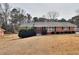 Brick ranch house with mature trees and a spacious yard at 879 Old Tucker Rd, Stone Mountain, GA 30087