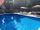 Relaxing blue inground pool with patio and lounge chairs at 879 Old Tucker Rd, Stone Mountain, GA 30087