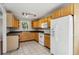 Kitchen with wood cabinets, white appliances, and tile floor at 1058 Hickory Rd, Canton, GA 30115