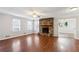 Living room with hardwood floors, stone fireplace, and ceiling fan at 1058 Hickory Rd, Canton, GA 30115