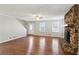 Living room with hardwood floors, stone fireplace, and ceiling fan at 1058 Hickory Rd, Canton, GA 30115