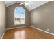 Spacious bedroom with hardwood floors and arched window at 160 Thistlewood Ln, Fayetteville, GA 30214