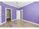 Bedroom with purple walls, closet, and tile floors at 160 Thistlewood Ln, Fayetteville, GA 30214