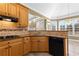 Kitchen with granite countertops, wood cabinets, and tile flooring at 160 Thistlewood Ln, Fayetteville, GA 30214