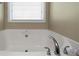 Bathroom with corner soaking tub and window at 18 Ponders Se Rd, Cartersville, GA 30121