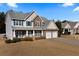 Two-story house with stone accents, two-car garage, and manicured lawn at 18 Ponders Se Rd, Cartersville, GA 30121