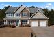 Two-story house with stone accents, two-car garage, and manicured lawn at 18 Ponders Se Rd, Cartersville, GA 30121