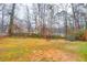 Large backyard with grassy area, trees, and a trampoline at 2767 Tony Dr, Lawrenceville, GA 30044