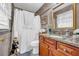 Clean bathroom with granite countertop, wooden vanity, and a shower/tub combo at 2767 Tony Dr, Lawrenceville, GA 30044