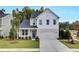 Two-story home with gray siding, blue door, and attached garage at 410 Newland Way, Acworth, GA 30102