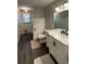 Updated bathroom with stylish vanity, marble countertop and grey flooring at 904 Little River Ln, Woodstock, GA 30189