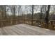 Large wooden deck with wooded views at 904 Little River Ln, Woodstock, GA 30189