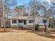 Ranch house with front porch and mature trees at 904 Little River Ln, Woodstock, GA 30189