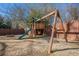 Playset in fenced backyard with grassy area at 9994 Inisfree Dr, Johns Creek, GA 30022