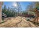 Landscaped backyard with playset and firepit at 9994 Inisfree Dr, Johns Creek, GA 30022