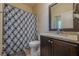 Bathroom with granite vanity, shower/tub combo, and patterned curtain at 9994 Inisfree Dr, Johns Creek, GA 30022