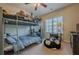 bedroom with bunk bed, desk, and ample natural light at 9994 Inisfree Dr, Johns Creek, GA 30022