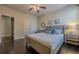 Bright bedroom with a comfortable bed, hardwood floors, and ceiling fan at 9994 Inisfree Dr, Johns Creek, GA 30022