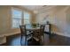 Charming breakfast nook with round table, four chairs, and decorative wall art at 9994 Inisfree Dr, Johns Creek, GA 30022