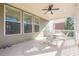 Covered deck with seating area and ceiling fan at 9994 Inisfree Dr, Johns Creek, GA 30022