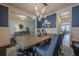 Bright dining room with a rustic wooden table and statement lighting at 9994 Inisfree Dr, Johns Creek, GA 30022