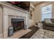 Elegant fireplace with granite surround, built-in shelving, and hardwood floors at 9994 Inisfree Dr, Johns Creek, GA 30022