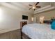 Main bedroom with hardwood floors, large TV and ensuite bathroom at 9994 Inisfree Dr, Johns Creek, GA 30022