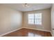 Simple bedroom with hardwood floors and a large window at 104 Holly Mill Village Dr, Canton, GA 30114