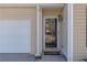 Front door entry with a glass door and a small welcome mat at 104 Holly Mill Village Dr, Canton, GA 30114