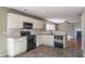 Modern kitchen with granite countertops and black appliances at 104 Holly Mill Village Dr, Canton, GA 30114