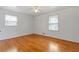 Bright bedroom with hardwood floors and ceiling fan at 1151 Mohican Trl, Stone Mountain, GA 30083