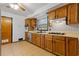 Bright kitchen featuring wood cabinets, gas stove, and tile floor at 1151 Mohican Trl, Stone Mountain, GA 30083