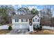 Charming two-story home with a two-car garage and a welcoming entrance with white stairs and a landscaped yard at 1620 Cedar Hl, Douglasville, GA 30134