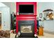 Red fireplace with black hearth and gas logs at 1620 Cedar Hl, Douglasville, GA 30134