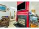 Bright living room features a red fireplace with a black hearth and wall-mounted television at 1620 Cedar Hl, Douglasville, GA 30134