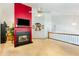 Inviting living room with a striking red accent wall, fireplace, and lots of natural light at 1620 Cedar Hl, Douglasville, GA 30134