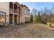 Landscaped backyard with expansive lawn and partial view of the home's exterior at 1696 Windsor Ne Pkwy, Atlanta, GA 30319